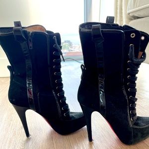 Black Christian Louboutin boots with almond toes and zip closure at outsoles.